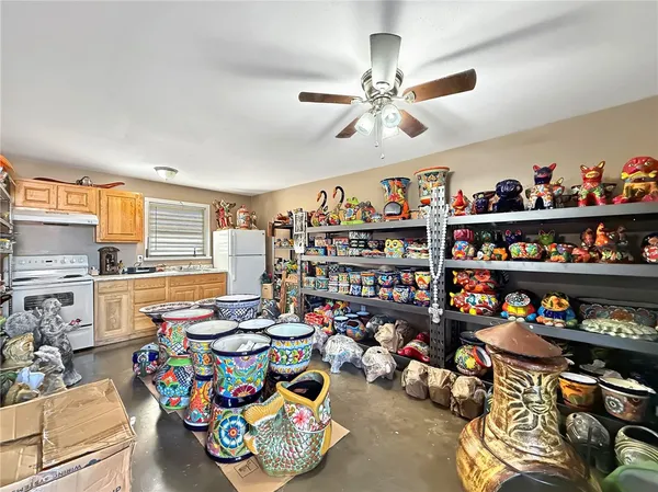 a living room with lots of furniture and a kitchen view