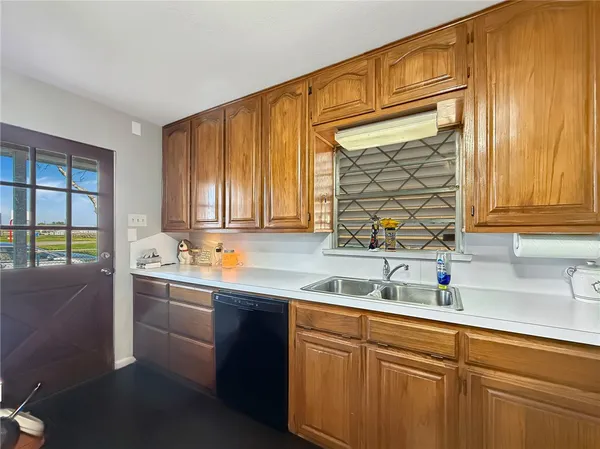 a kitchen with stainless steel appliances a sink stove and cabinets