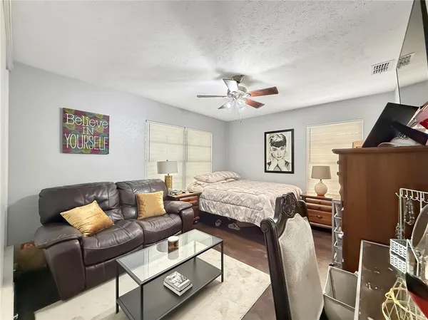 a bedroom with furniture and wooden floor