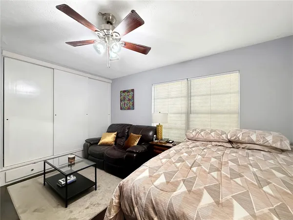 a bedroom with two beds and two windows