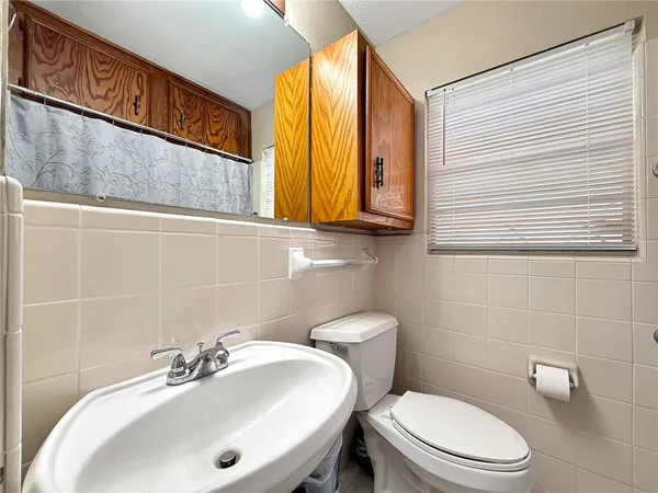 a bathroom with a sink a mirror and a toilet