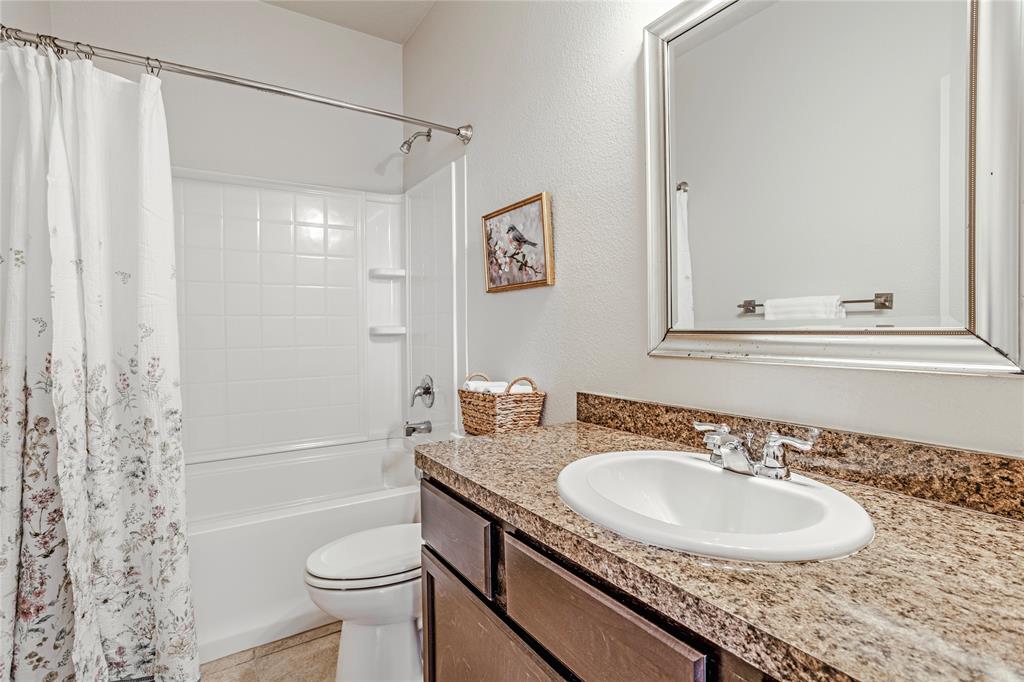 345 Chestnut Lane Ponder, TX 76259 - Photo 13 of 29 a bathroom with a granite countertop sink toilet and shower