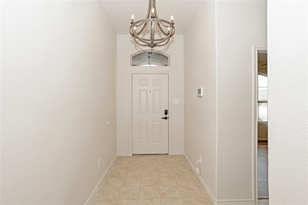 345 Chestnut Lane Ponder, TX 76259 - Photo 14 of 29 a view of a hallway with a chandelier