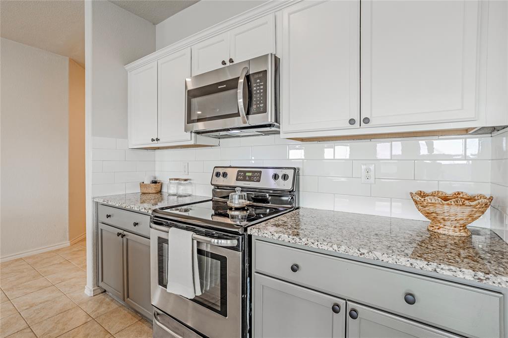 345 Chestnut Lane Ponder, TX 76259 - Photo 17 of 29 a kitchen with stainless steel appliances granite countertop a sink a stove and microwave