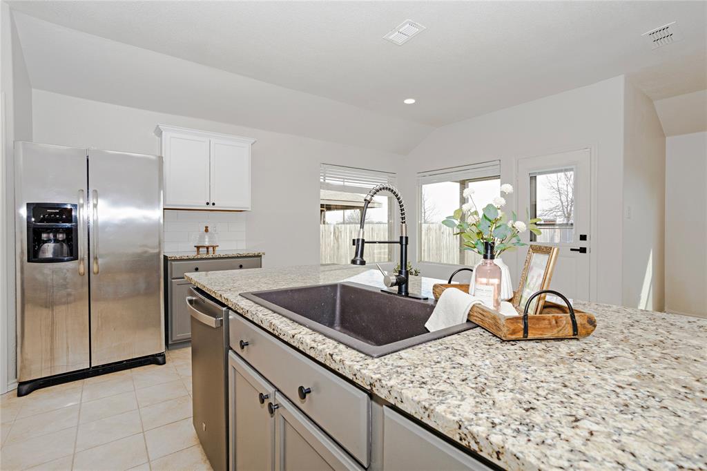 345 Chestnut Lane Ponder, TX 76259 - Photo 19 of 29 a kitchen with stainless steel appliances granite countertop a sink stove and refrigerator