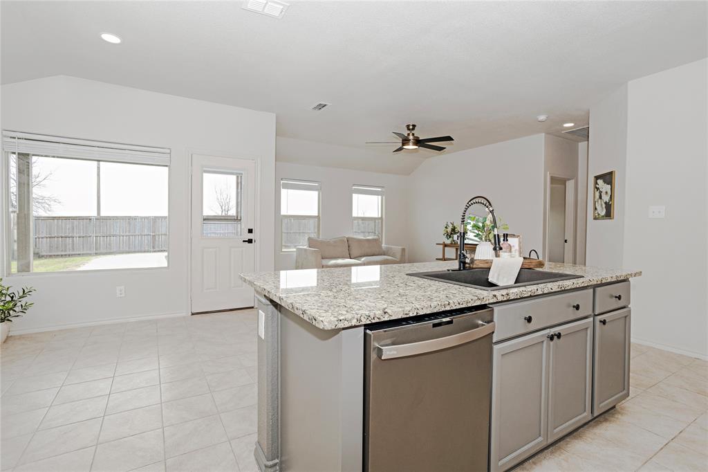 345 Chestnut Lane Ponder, TX 76259 - Photo 20 of 29 a bathroom with a granite countertop sink a large mirror and vanity