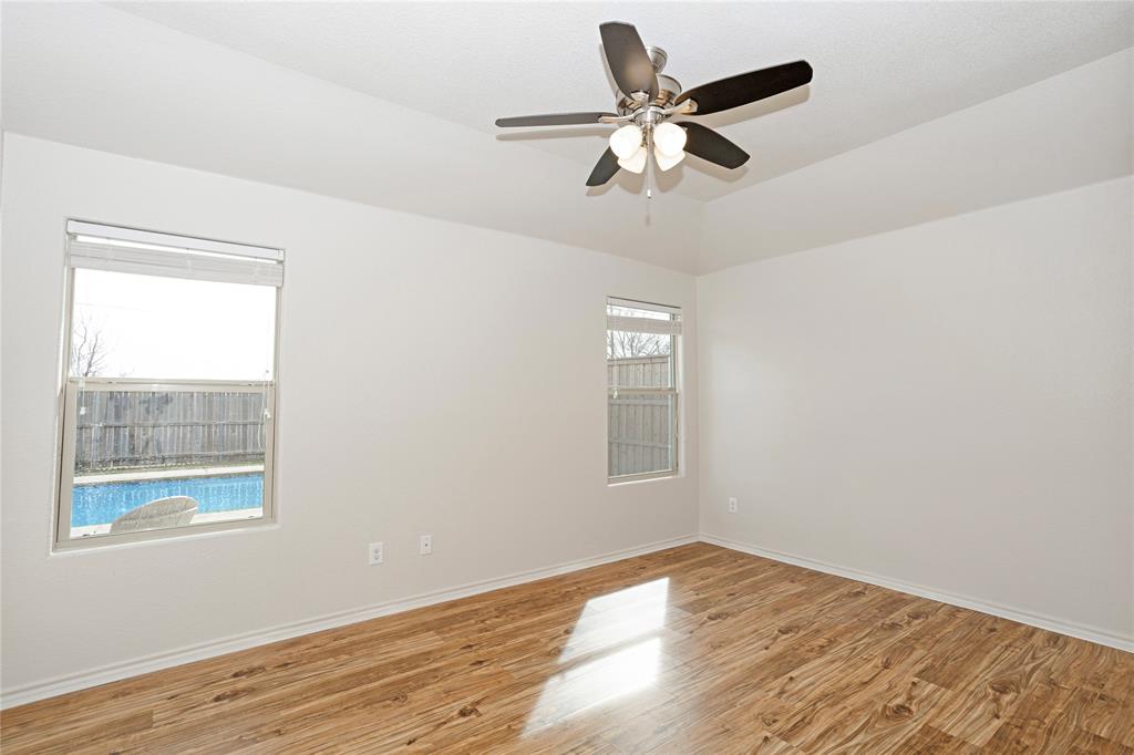 345 Chestnut Lane Ponder, TX 76259 - Photo 21 of 29 an empty room with wooden floor fan and windows