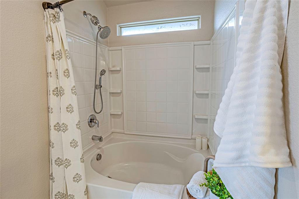 345 Chestnut Lane Ponder, TX 76259 - Photo 23 of 29 a bathroom with a bathtub and shower