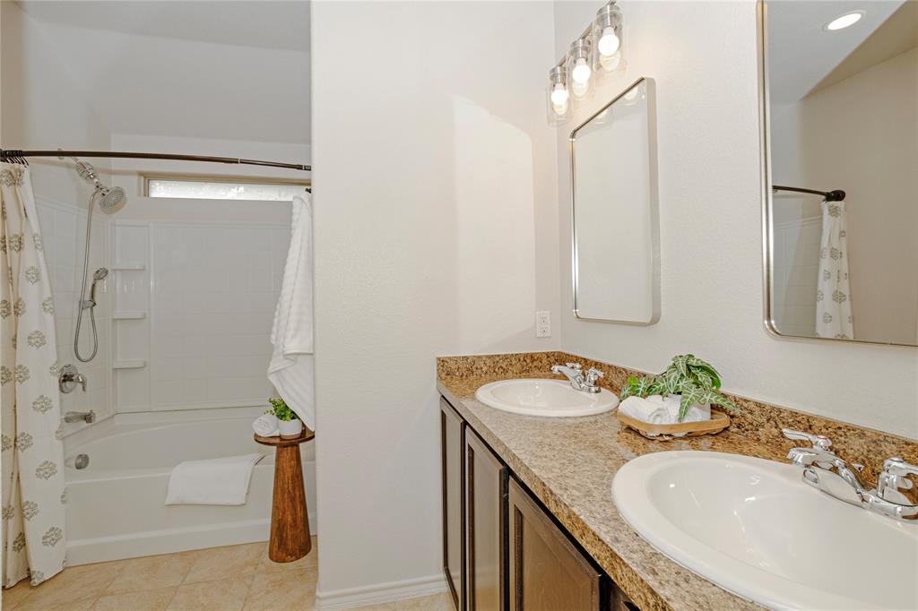 345 Chestnut Lane Ponder, TX 76259 - Photo 24 of 29 a bathroom with a granite countertop sink and a mirror