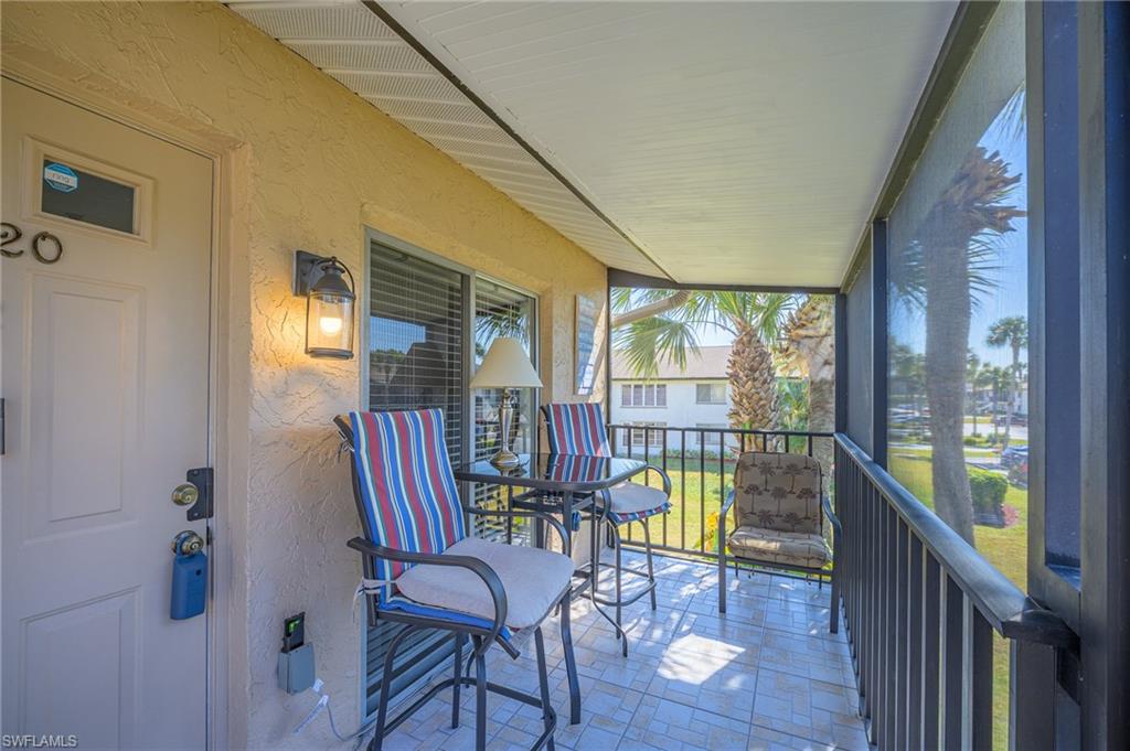 3420 Frosty Way, Unit 4902 Naples, FL 34112 - Photo 15 of 31 a view of a dining room with furniture window and wooden floor