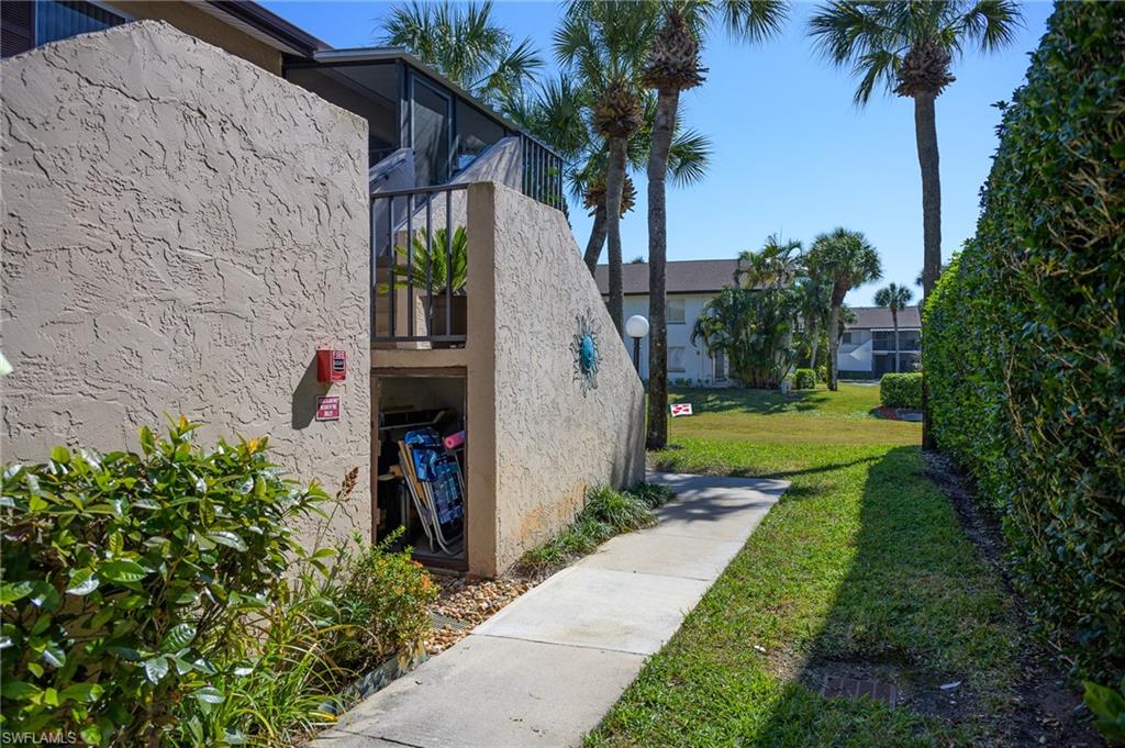 3420 Frosty Way, Unit 4902 Naples, FL 34112 - Photo 16 of 31 a view of a garden in front of a house