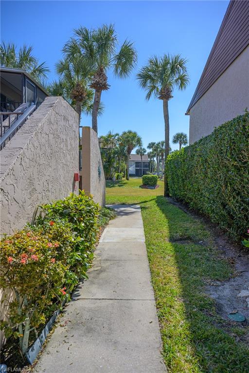 3420 Frosty Way, Unit 4902 Naples, FL 34112 - Photo 18 of 31 a view of a garden with a fountain