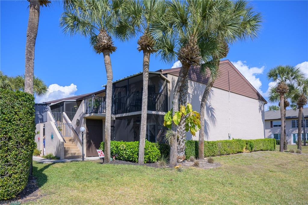 3420 Frosty Way, Unit 4902 Naples, FL 34112 - Photo 19 of 31 a front view of a house with garden