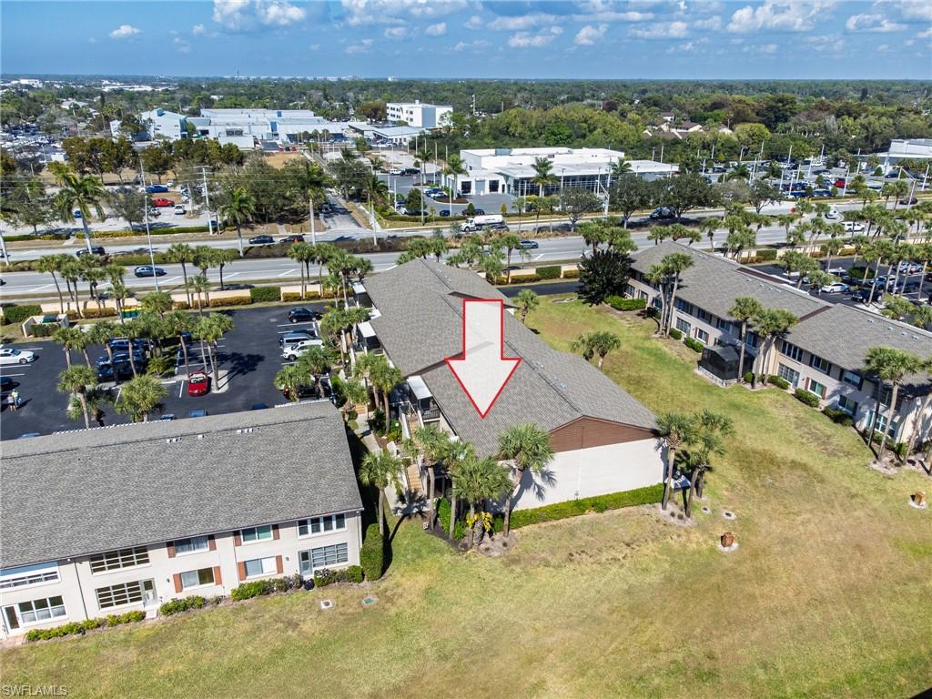 3420 Frosty Way, Unit 4902 Naples, FL 34112 - Photo 21 of 31 an aerial view of a house with a yard and lake view