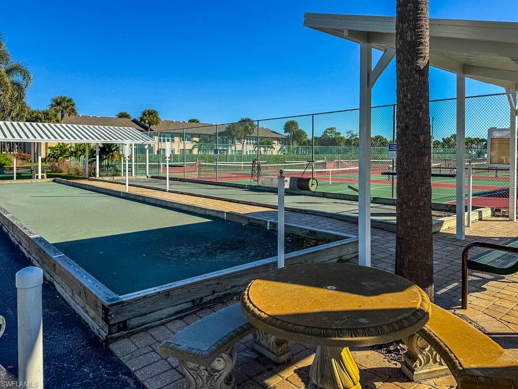 3420 Frosty Way, Unit 4902 Naples, FL 34112 - Photo 24 of 31 a view of a balcony with two chairs and a table