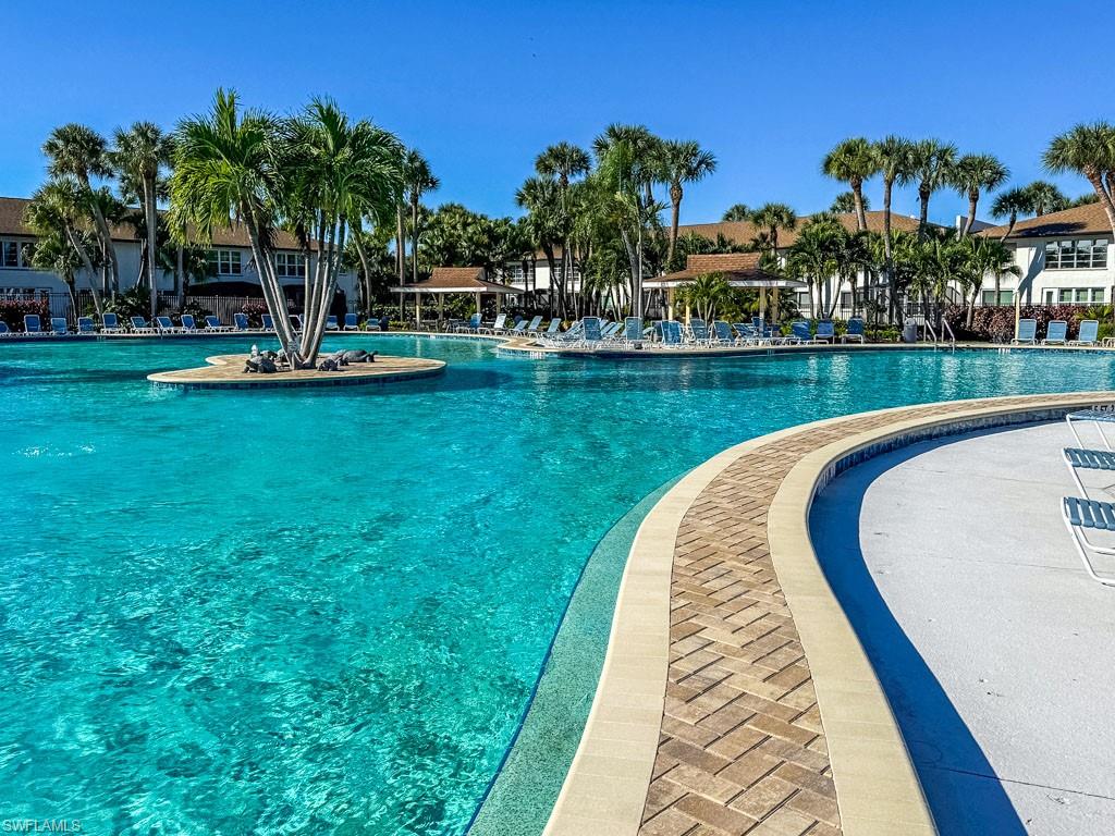 3420 Frosty Way, Unit 4902 Naples, FL 34112 - Photo 28 of 31 a view of a swimming pool with a garden and plants