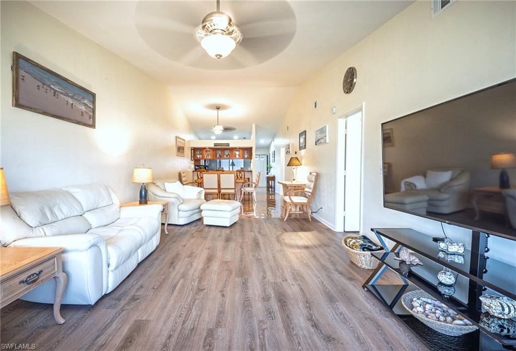 3420 Frosty Way, Unit 4902 Naples, FL 34112 - Photo 5 of 31 a living room with furniture and a wooden floor