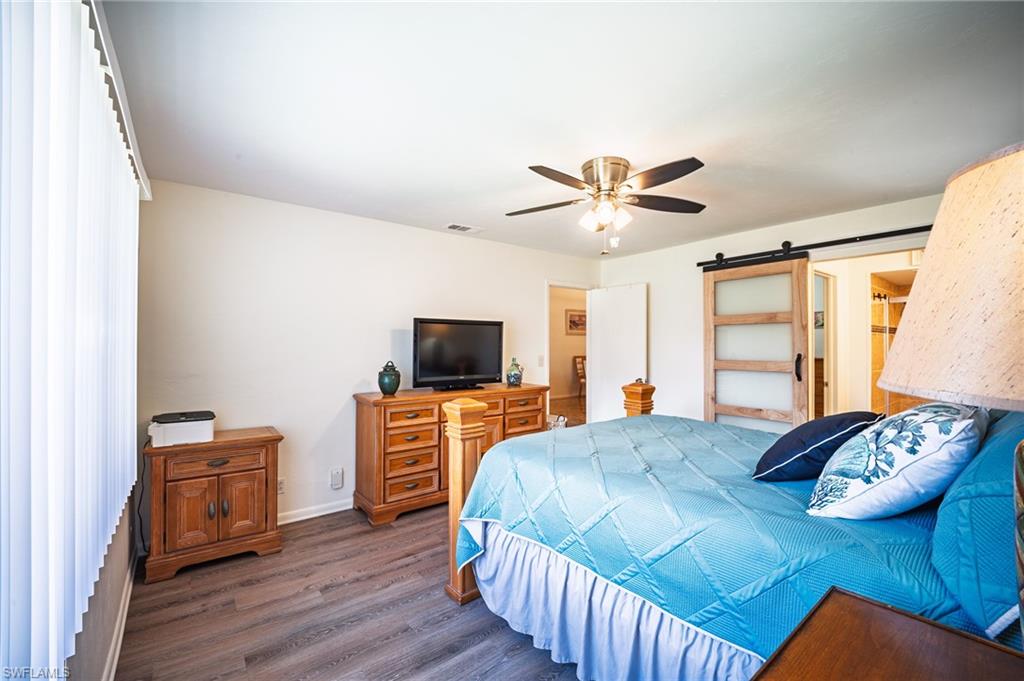 3420 Frosty Way, Unit 4902 Naples, FL 34112 - Photo 8 of 31 a bedroom with furniture and a flat screen tv