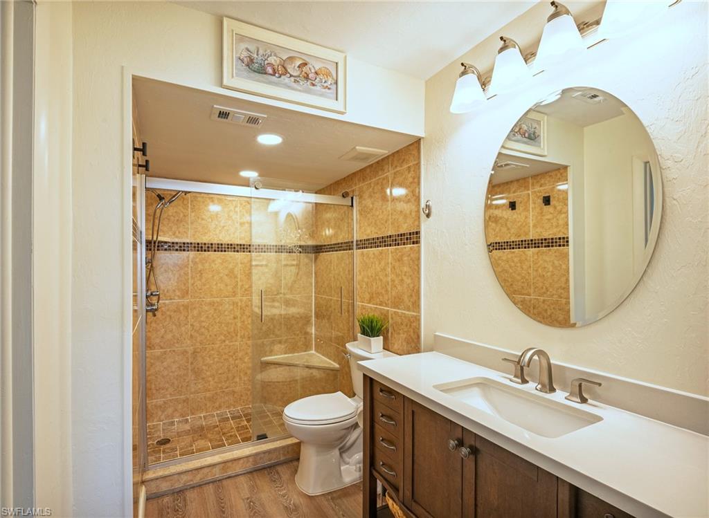 3420 Frosty Way, Unit 4902 Naples, FL 34112 - Photo 9 of 31 a bathroom with a sink a toilet and shower