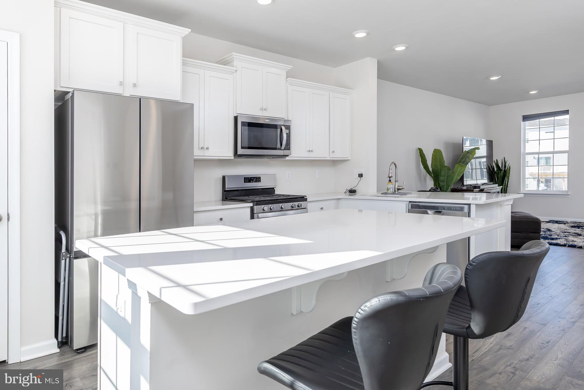 18 Foundry Boulevard Mount Holly, NJ 08060 - Photo 4 of 20 a kitchen with stainless steel appliances a kitchen island a stove a table and chairs