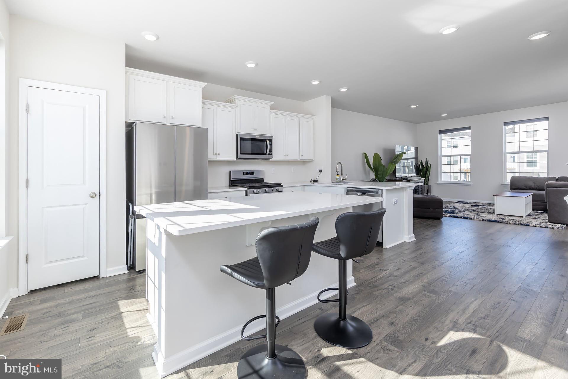 18 Foundry Boulevard Mount Holly, NJ 08060 - Photo 6 of 20 a kitchen with stainless steel appliances a refrigerator a stove a sink a dining table and chairs