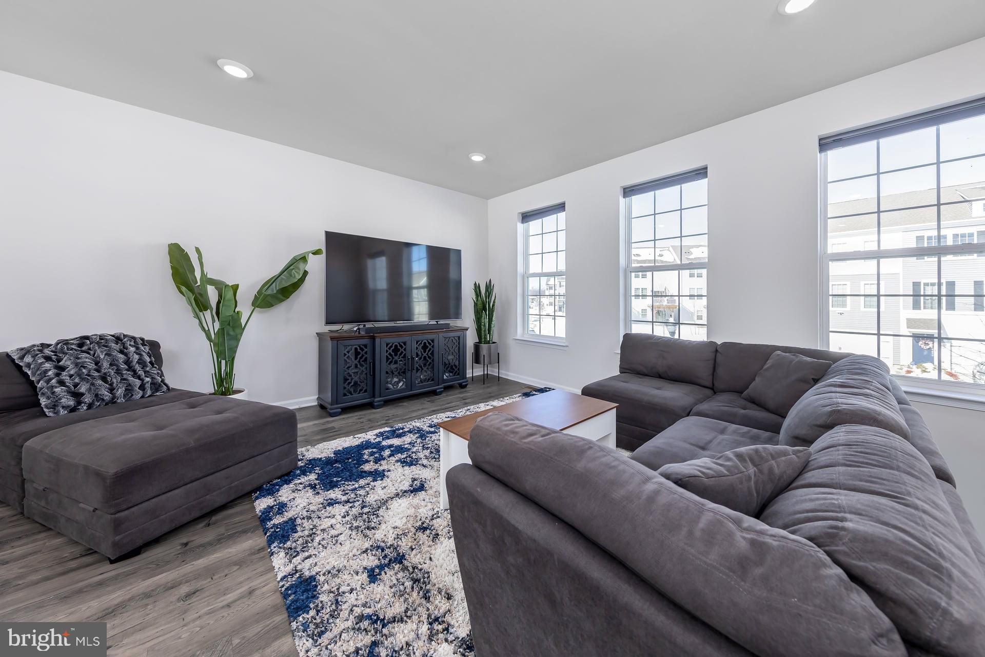 18 Foundry Boulevard Mount Holly, NJ 08060 - Photo 9 of 20 a living room with furniture a flat screen tv and a large window