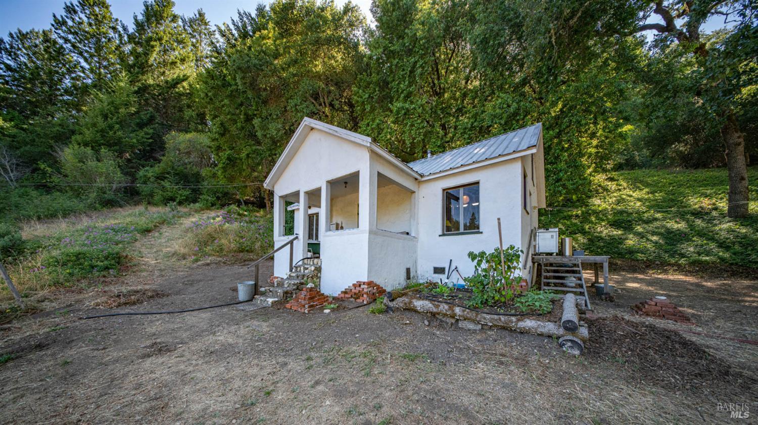 8868 Mill Creek Road Healdsburg, CA 95448 - Photo 1 of 36 Self-sufficient, low-impact cabin with spring-fed water, solar power, and a composting toilet.