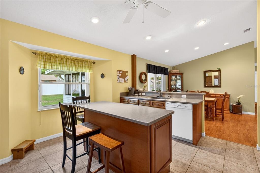 1918 Umbrella Tree Drive Edgewater, FL 32141 - Photo 11 of 44 a large kitchen with a table and chairs