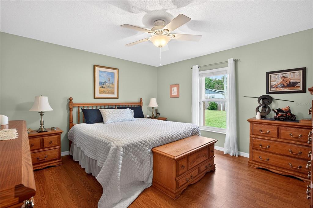 1918 Umbrella Tree Drive Edgewater, FL 32141 - Photo 14 of 44 a spacious bedroom with a bed and a window