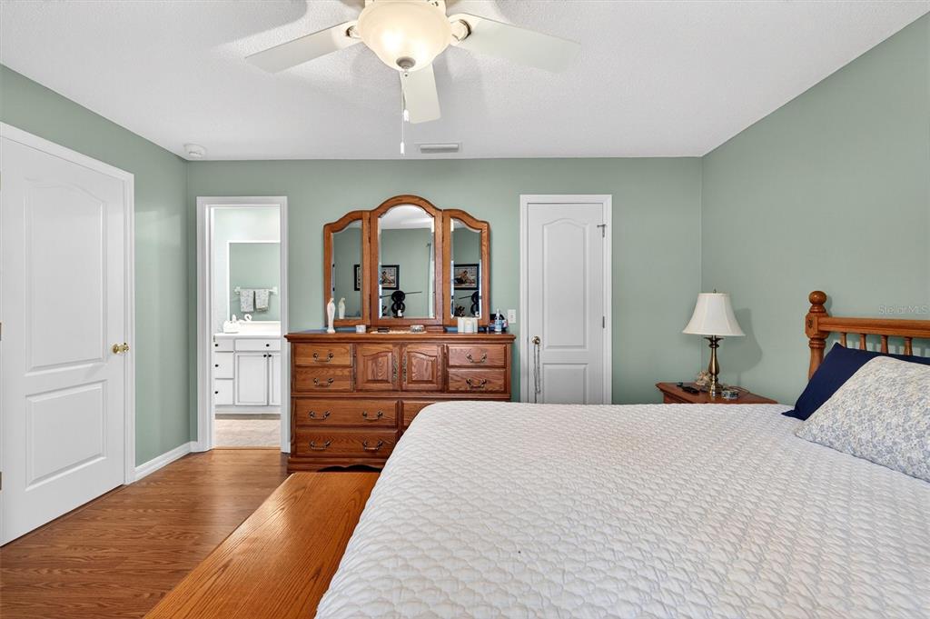1918 Umbrella Tree Drive Edgewater, FL 32141 - Photo 15 of 44 a bedroom with a bed and a chandelier