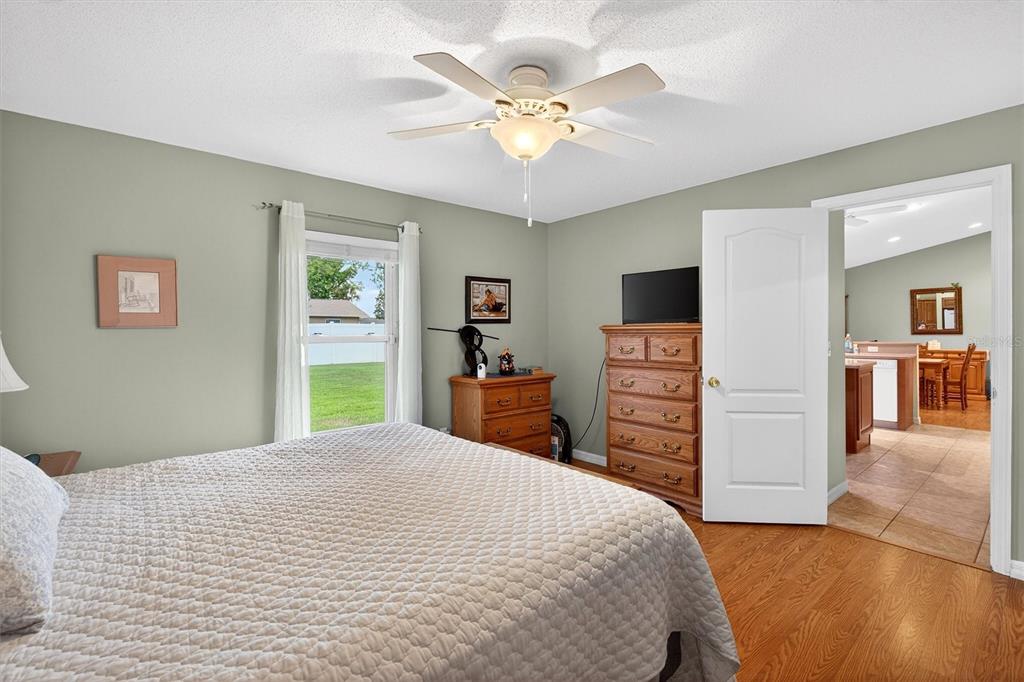 1918 Umbrella Tree Drive Edgewater, FL 32141 - Photo 16 of 44 a bedroom with a large bed a chandelier and closet