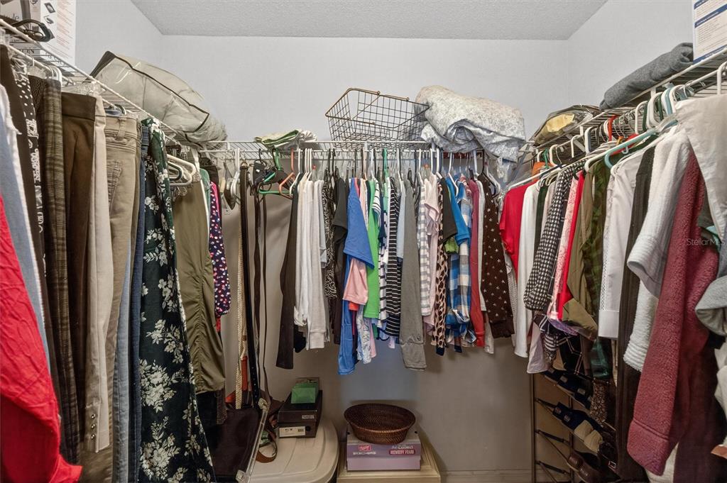 1918 Umbrella Tree Drive Edgewater, FL 32141 - Photo 17 of 44 a view of walk in closet with clothes