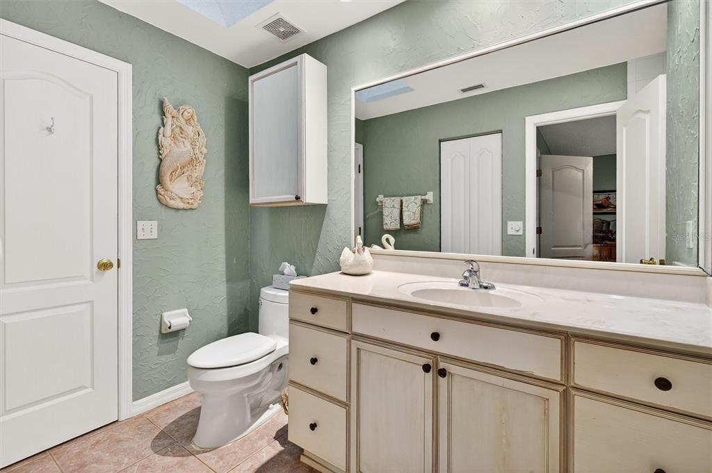 1918 Umbrella Tree Drive Edgewater, FL 32141 - Photo 18 of 44 a bathroom with a granite countertop toilet sink and mirror