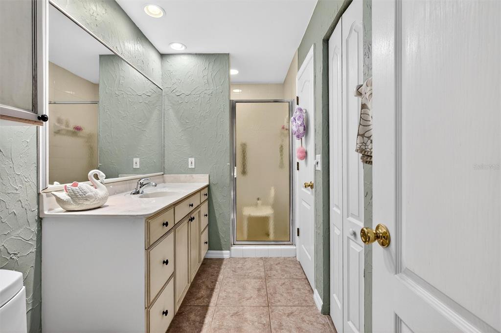 1918 Umbrella Tree Drive Edgewater, FL 32141 - Photo 19 of 44 a bathroom with a granite countertop sink a mirror and a shower