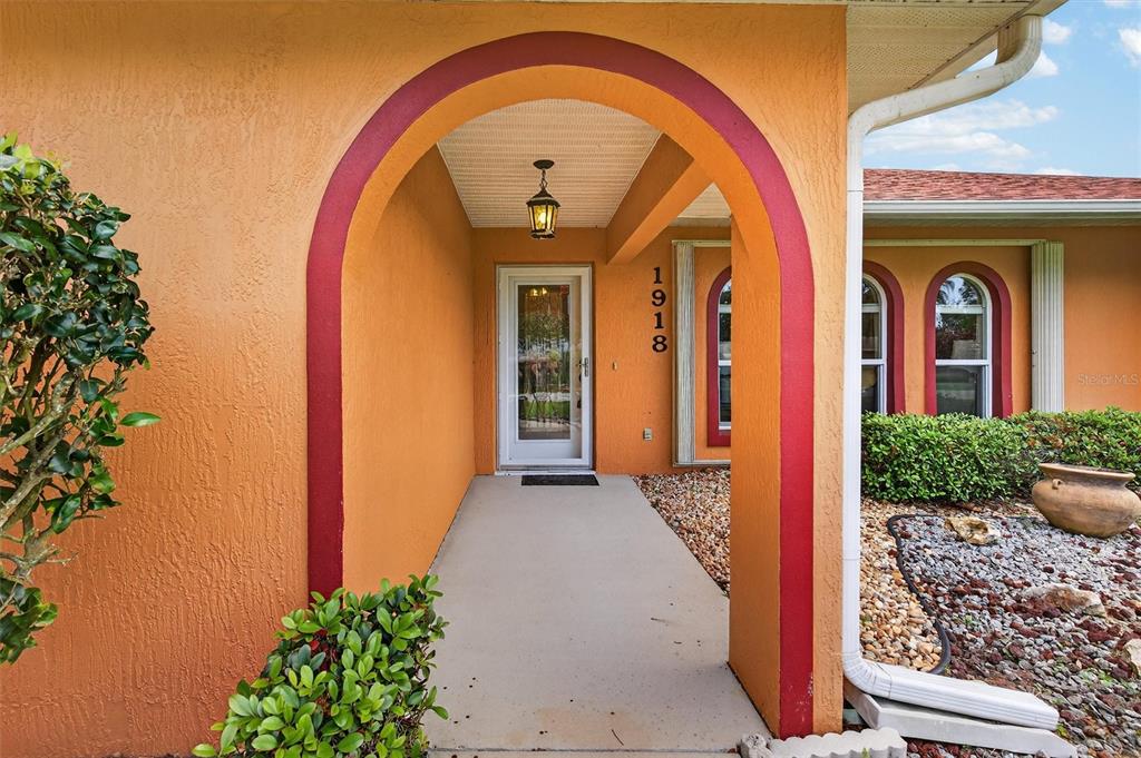 1918 Umbrella Tree Drive Edgewater, FL 32141 - Photo 2 of 44 a view of a brick house with potted plants