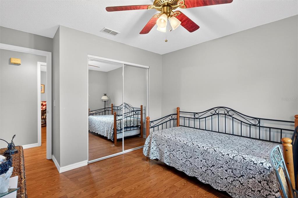 1918 Umbrella Tree Drive Edgewater, FL 32141 - Photo 21 of 44 a bedroom with bed and a chandelier