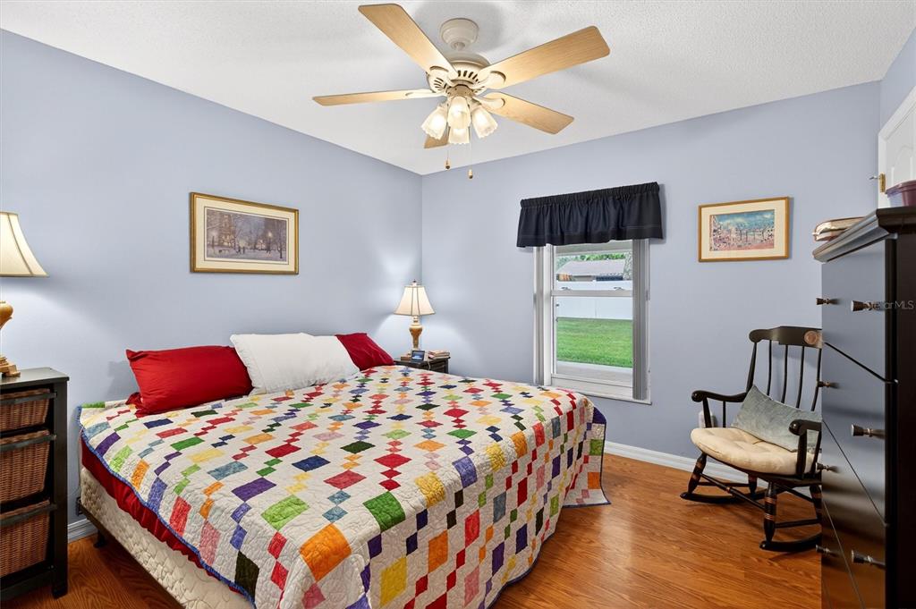 1918 Umbrella Tree Drive Edgewater, FL 32141 - Photo 23 of 44 a bedroom with a bed a chair and a window