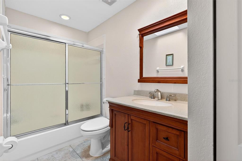 1918 Umbrella Tree Drive Edgewater, FL 32141 - Photo 26 of 44 a bathroom with a toilet a sink and shower