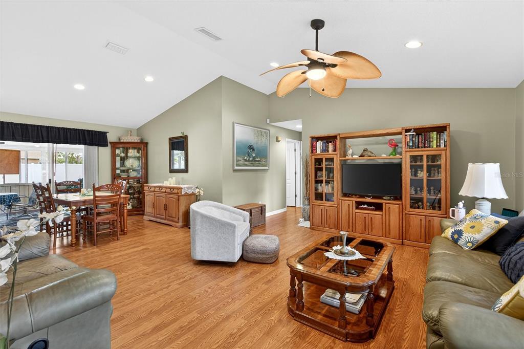 1918 Umbrella Tree Drive Edgewater, FL 32141 - Photo 3 of 44 a living room with furniture a flat screen tv and a large window