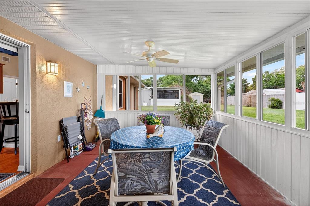 1918 Umbrella Tree Drive Edgewater, FL 32141 - Photo 31 of 44 a dining room with furniture a chandelier and wooden floor