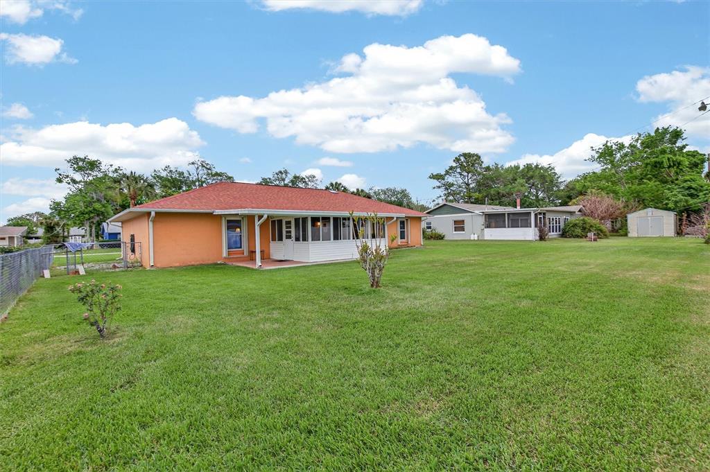 1918 Umbrella Tree Drive Edgewater, FL 32141 - Photo 33 of 44 a view of a house with a backyard