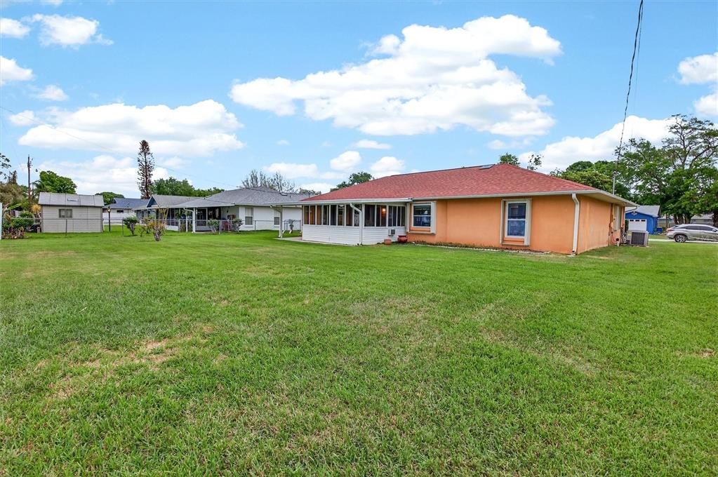 1918 Umbrella Tree Drive Edgewater, FL 32141 - Photo 34 of 44 a view of a house with a yard and sitting area