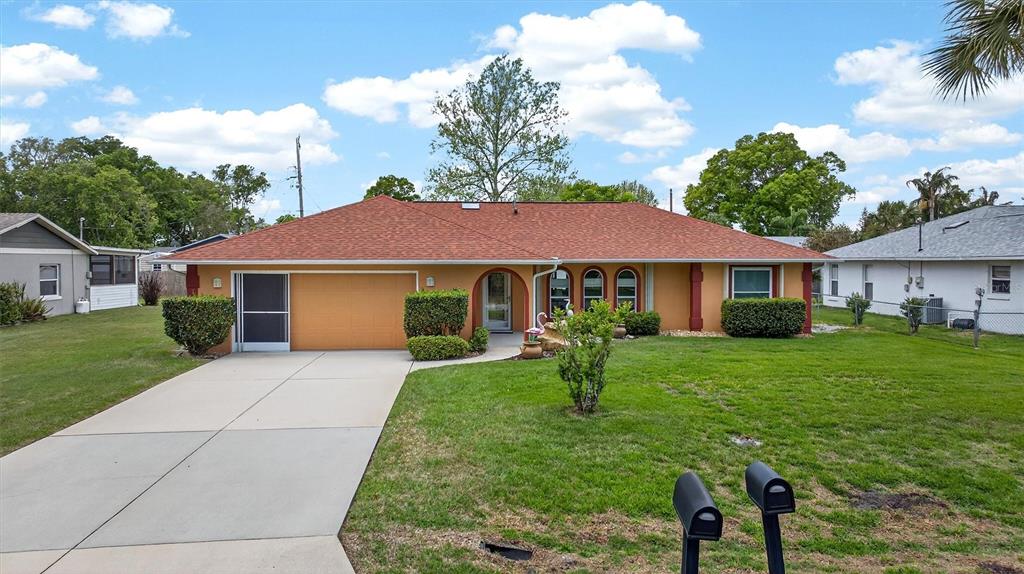 1918 Umbrella Tree Drive Edgewater, FL 32141 - Photo 36 of 44 a front view of a house with a yard