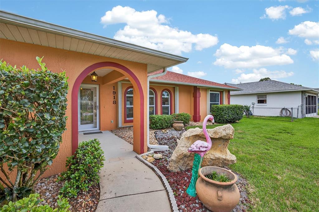 1918 Umbrella Tree Drive Edgewater, FL 32141 - Photo 43 of 44 a front view of a house with porch and garden