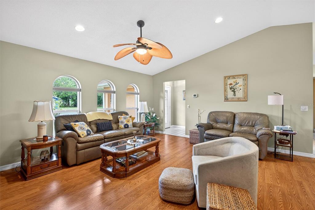 1918 Umbrella Tree Drive Edgewater, FL 32141 - Photo 6 of 44 a living room with furniture a fireplace and a large window