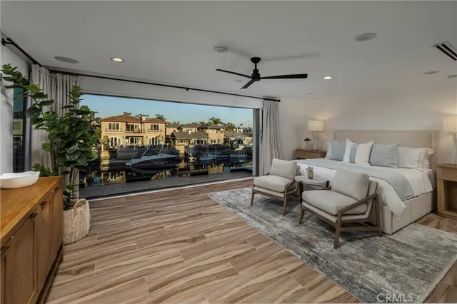 a bedroom with furniture and a large window