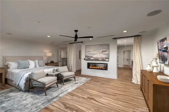 a spacious bedroom with a large bed and a chandelier