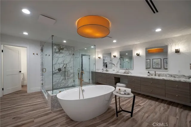 a large spacious bathroom with a large tub shower and sink