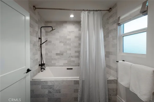a bathroom with a bathtub and a shower