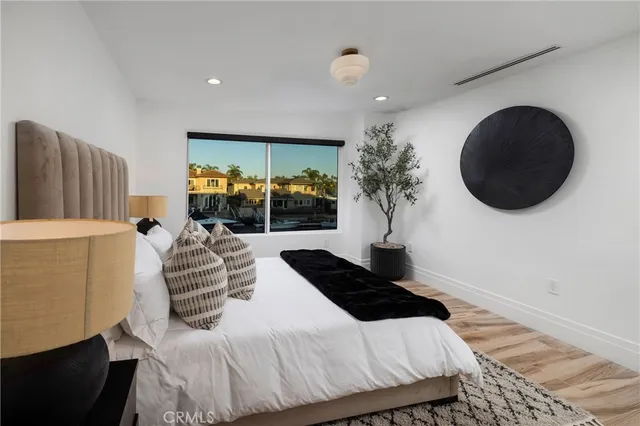 a bedroom with a large bed and a large window